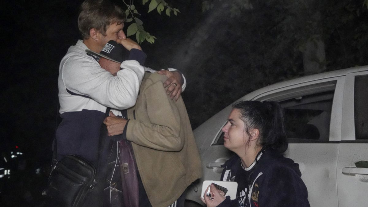 Residents outside their apartment building destroyed by Russian strike