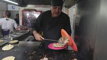 Newly minted Michelin-starred chef Arturo Rivera Martínez prepares an order of tacos at the Tacos El Califa de León taco stand, in Mexico City, Wednesday, May 15, 2024.