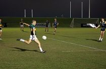 Kerry team player kicking for a point on the scoreboard. 