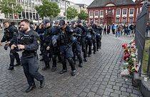 German police officers commemorate a colleague in Mannheim Germany, after learning that a police officer, who was stabbed two days ago there has died on Sunday, June 2, 2024. 