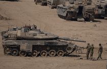 Israeli soldiers work on a tank in a staging area near the Israeli-Gaza border in southern Israel, Monday, June 3, 2024. 