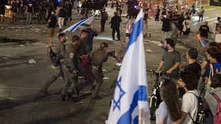 Israeli police remove a person protesting against Prime Minister Benjamin Netanyahu's government at a rally in Tel Aviv, June 1, 2024