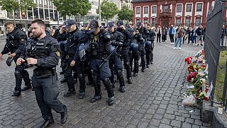 German police officers commemorate a colleague in Mannheim Germany, after learning that a police officer, who was stabbed two days ago there has died on Sunday, June 2, 2024. 