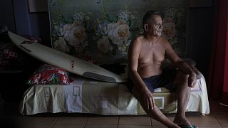 Teahupo'o native Gregory Parker poses for a portrait in the beachfront bungalow that he will rent out to Olympic accredited officials.