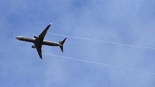 FILE - An Alaska Airlines Boeing-made airplane flies above Boeing's newly expanded 737 delivery center, Monday, Oct. 19, 2015.