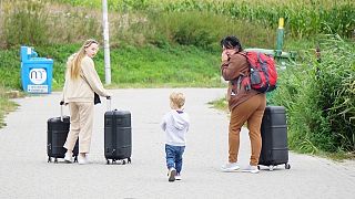 Women cross back into Ukraine from Poland.