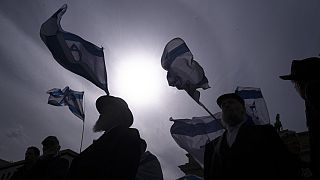 FILE - People take part in a demonstration of solidarity with Israel in Berlin, Sunday, April 14, 2024 following the Iranian attacks on Israel overnight.