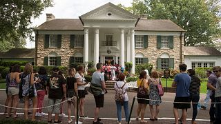 Fans wait in line outside Graceland Tuesday, Aug. 15, 2017, in Memphis, Tenn. 