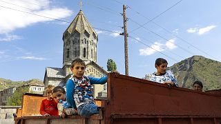 Ethnic Armenian children from Nagorno-Karabakh look from a truck after arriving in Armenia's Goris in Syunik region, Armenia, on Sept. 28, 2023. 