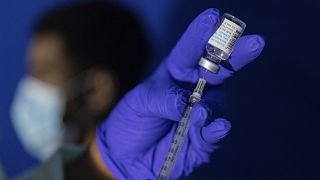 A family nurse practitioner prepares a syringe with the Mpox vaccine.