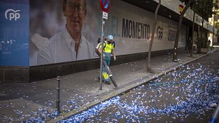 A worker cleans the street after celebrations at the conservative Popular Party headquarters in Madrid, Spain, Monday, July 24, 2023.