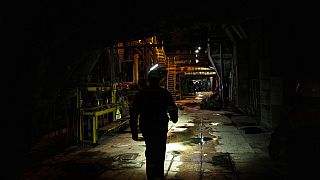 A worker walks along an internal corridor in a damaged DTEK thermal power plant after a Russian attack in Ukraine, Thursday, May 2, 2024.