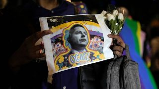 A demonstrator holds a picture of Aguascalientes state electoral court magistrate Jesus Ociel Baena in Mexico City