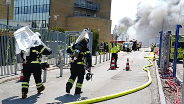 Firefighters work to extinguish a fire at the Novo Nordisk headquarters in Bagsvaerd, near Copenhagen, Denmark.