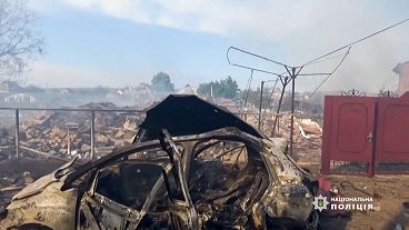 Destroyed residential buildings and car