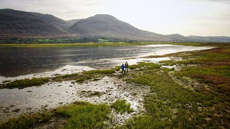 Dr. Grace Cott, UCD Coastal Wetland Ecologist, and Euronews reporter Denis Loctier at the Derrymore salt marhes study site, Ireland