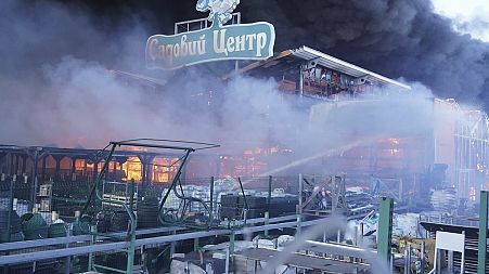 Firefighters put out a fire after two guided bombs hit a large construction supplies store in Kharkiv, Ukraine