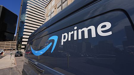 The logo adorns the side of an Amazon delivery van Tuesday, May 14, 2024, in downtown Denver. AP Photo/David Zalubowski)