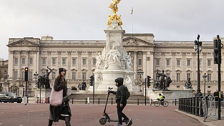 A general view of Buckingham Palace one, of the official residences of King Charles III, as pedestrians walk past in London, Tuesday, Feb. 6, 2024.