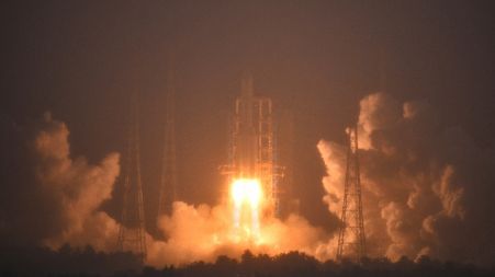 A Long March-5 rocket, carrying the Chang'e-6 spacecraft, blasts off from its launchpad at the Wenchang Space Launch Site.