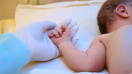 Baby in a hospital bed.