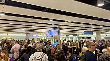 In this screenshot from an AP video, hoardes of travellers are seen stuck at Heathrow airport after e-gates failed on Tuesday