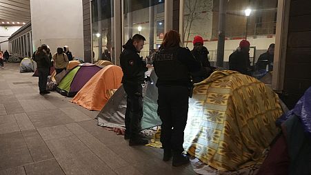 Police officers evicted migrants from a makeshift camp in Paris a few steps from the Seine River (AP Photo/Nicolas Garriga) 