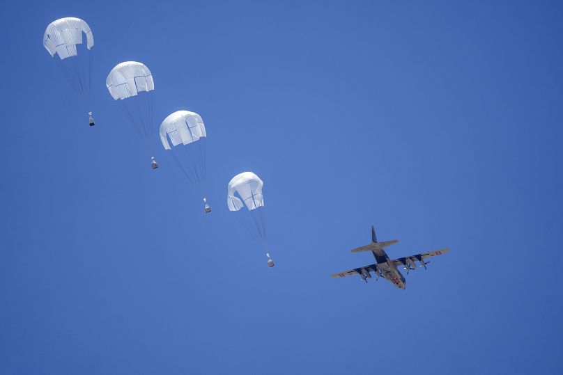 An aircraft airdrops humanitarian aid over Khan Younis, May 30, 2024