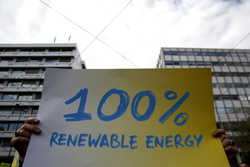 A protester raises a placard during the Global Climate March, a day ahead of the 2015 Paris Climate Change summit, in Athens, November 2019