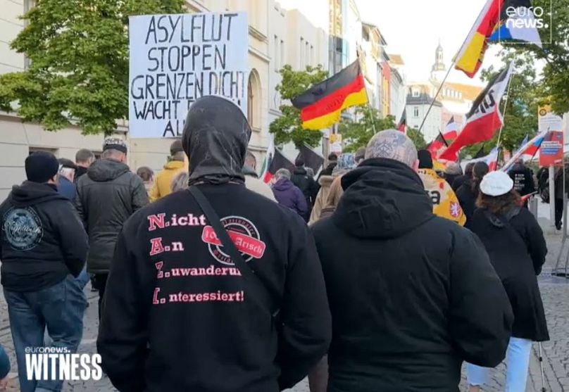 Monday march in Gera. Person wearing a T-Shirt with the slogan: “Not interested in immigration- 100% Aryan”